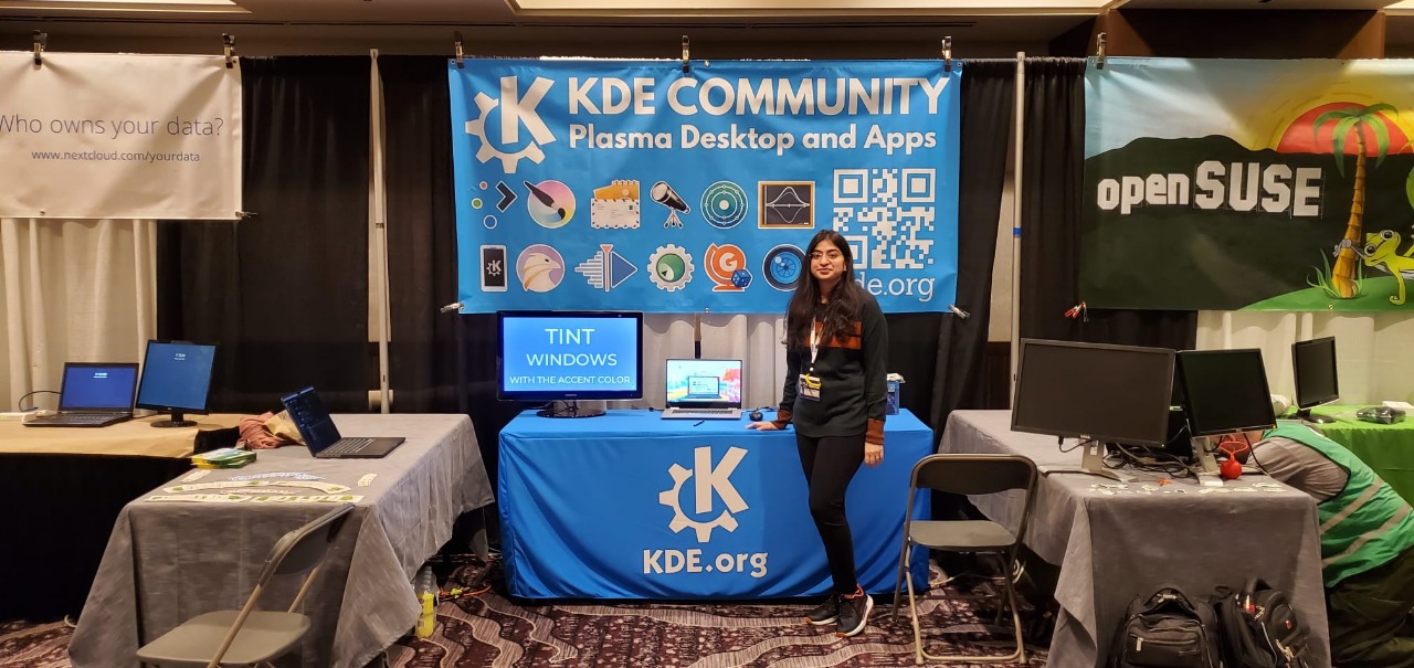 Bhavisha stands in front of the booth at Scalex19.